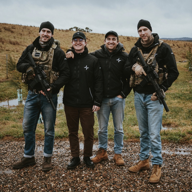 Four colleagues together on a range on a cold day.