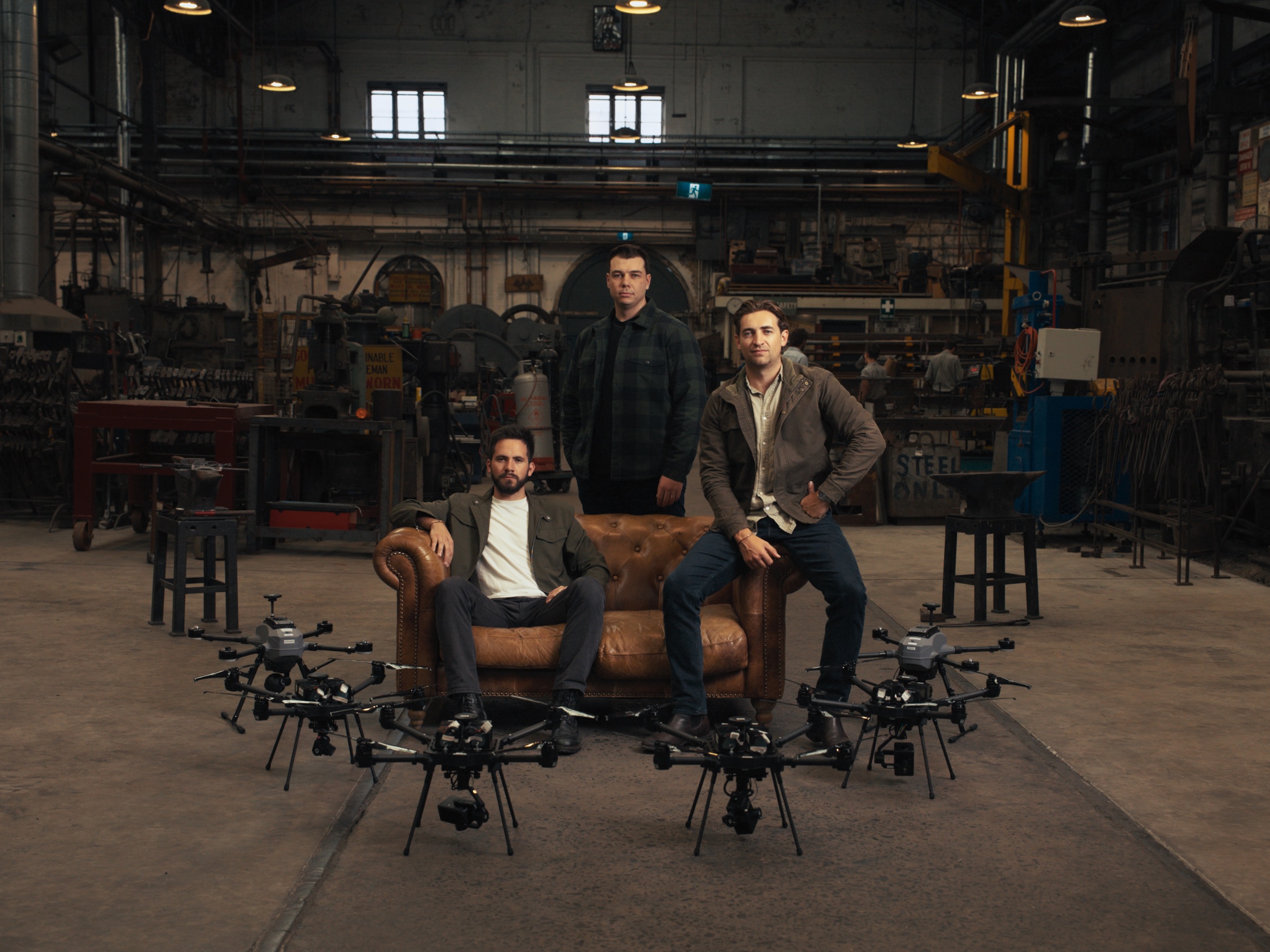 Breaker's three founders in a Sydney workshop, surrounded by drones.