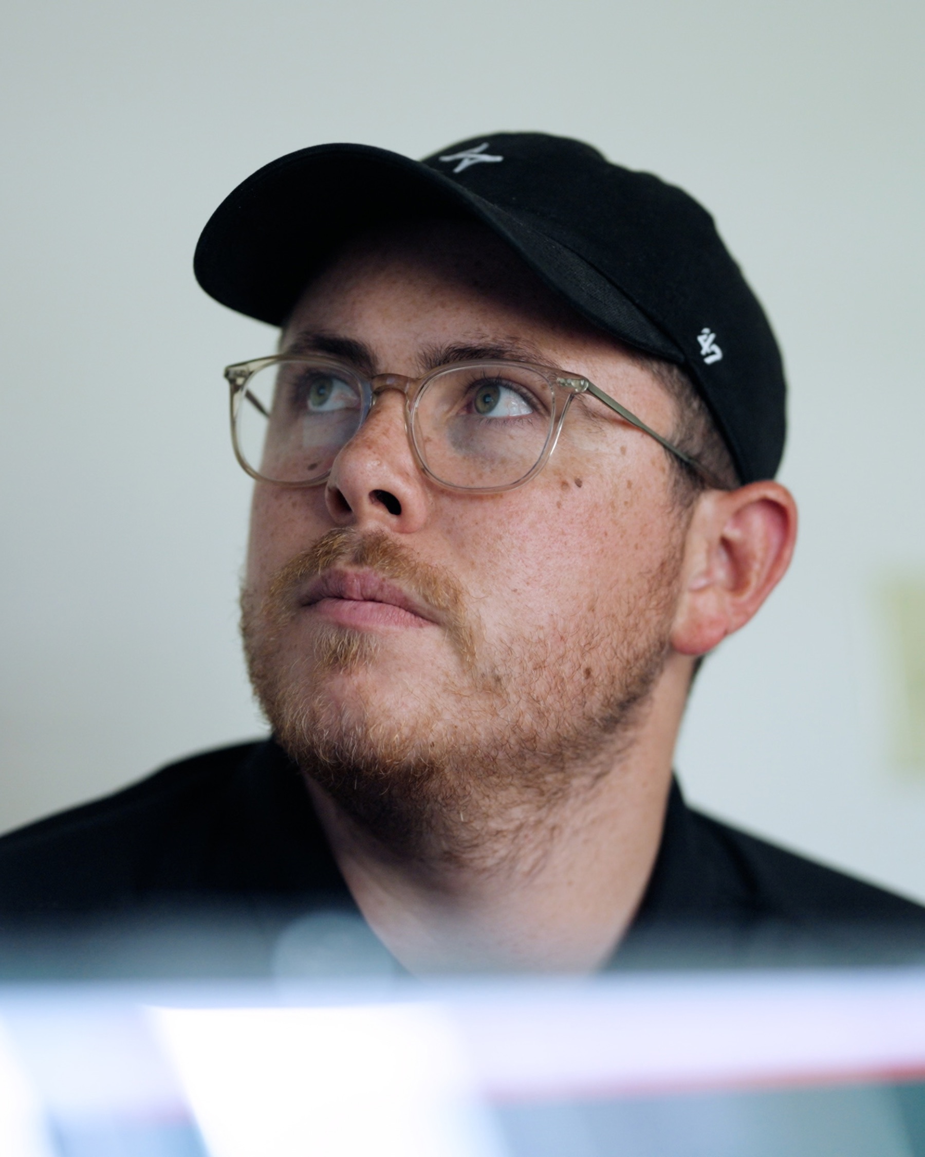 Sam Comerford at a desk, looking up from a monitor.