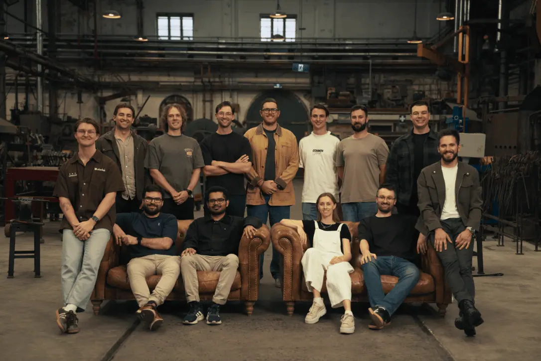 The Breaker team, fourteen people, in an industrial workshop.